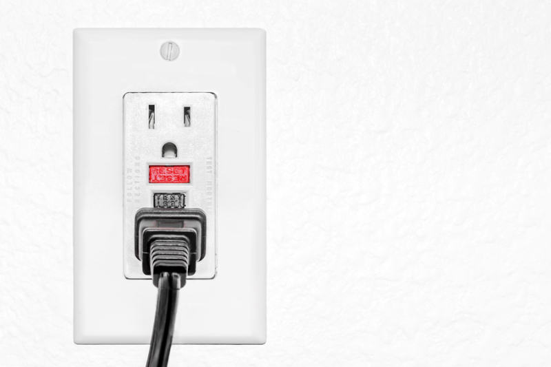 Outlet receptacle with plug inserted.