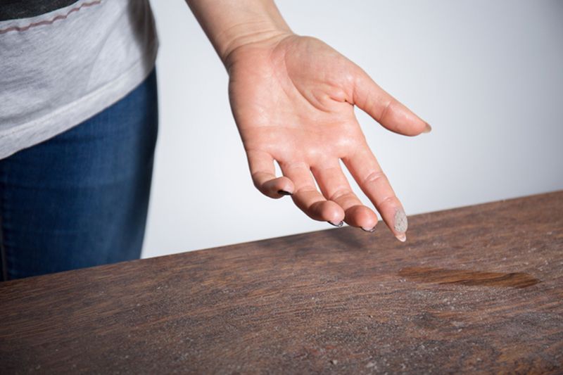 Image of a dusty table. How to Reduce Dust in Your Home.