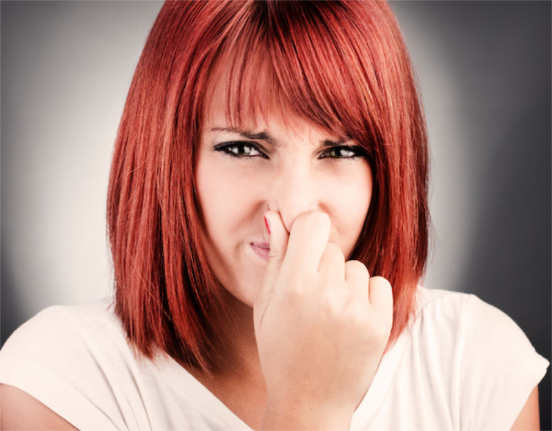Woman plugging nose.