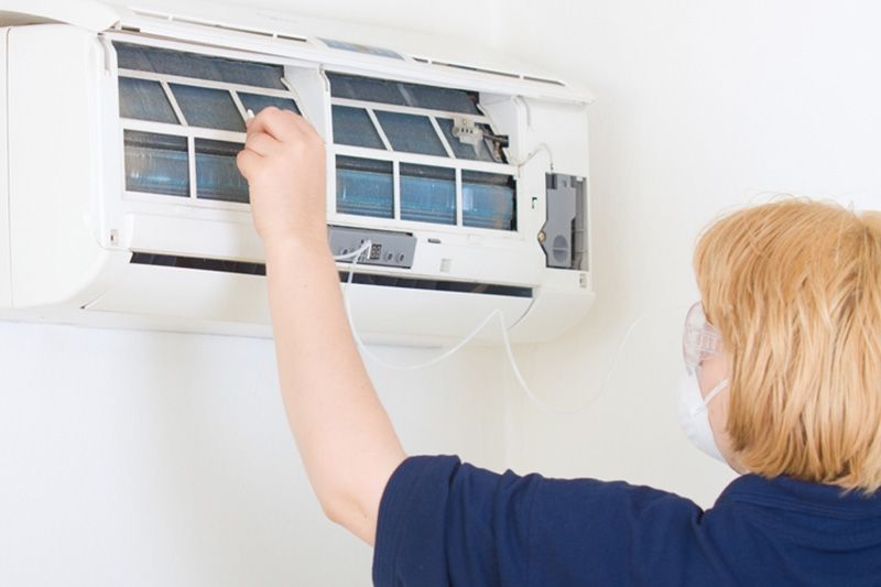 Image of someone working on ductless system. What Maintenance Is Needed for a Ductless System?